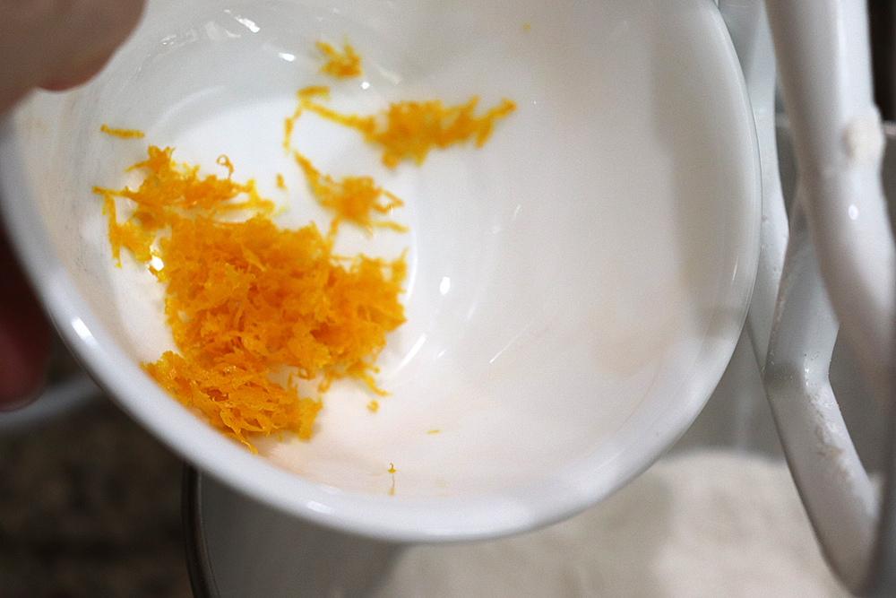 Adding orange zest to the flour mixture