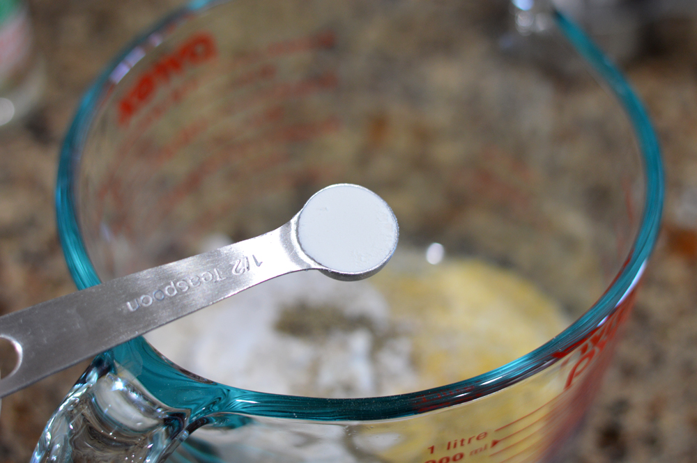 Measuring spoon full of baking soda for Vegan Corn Fritters