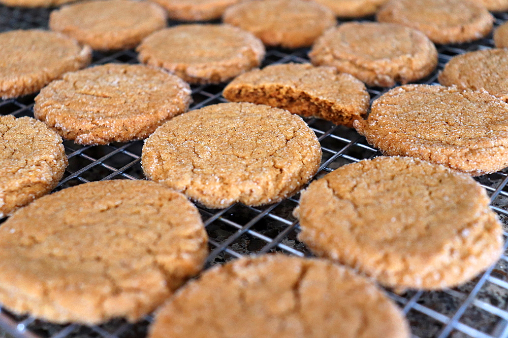 Baked cookies on a rack with one bite taken out