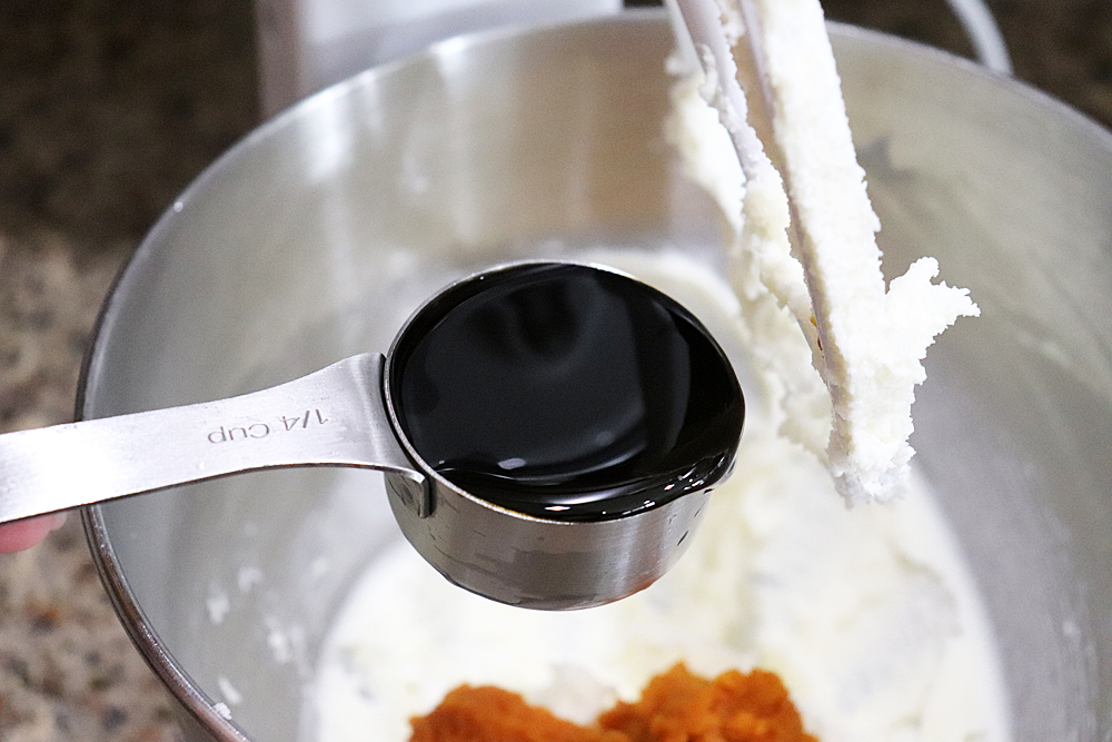 Adding molasses to the bowl of an electric mixer