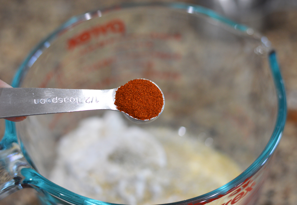 Measuring spoon full of paprika for Vegan Corn Fritters