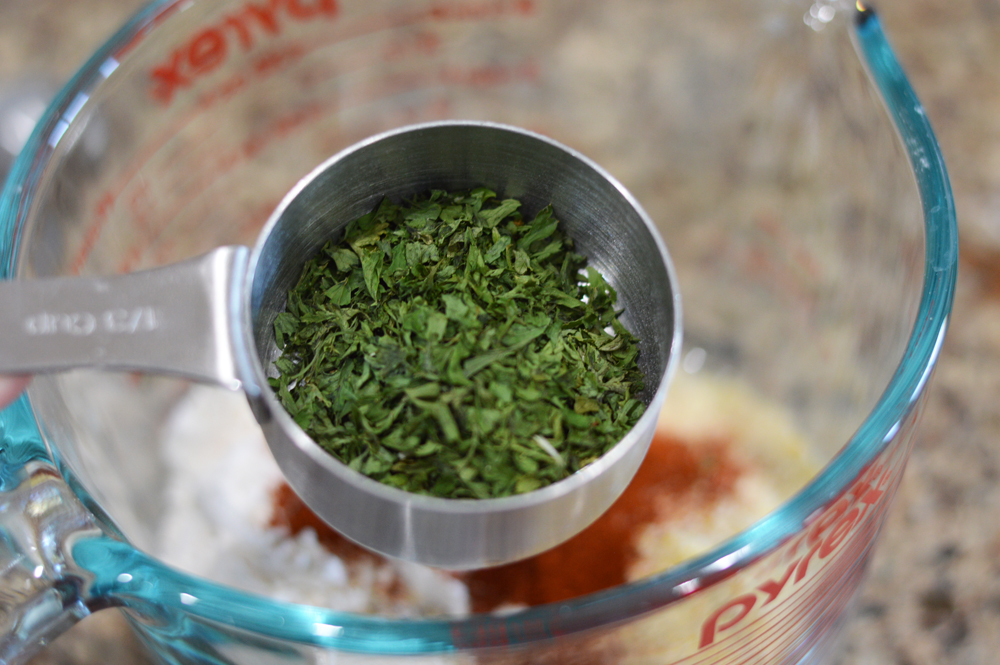 Measuring cup full of parsley for Measuring spoon full of salt for Vegan Corn Fritters