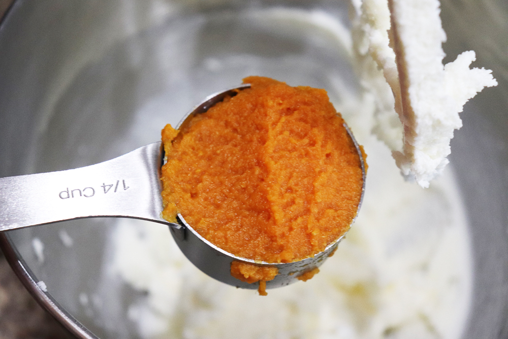 Adding pumpkin puree to the electric mixer