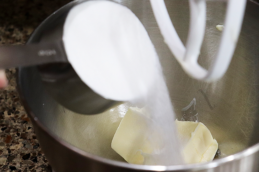 Adding sugar to the vegan margarine in an electric mixer