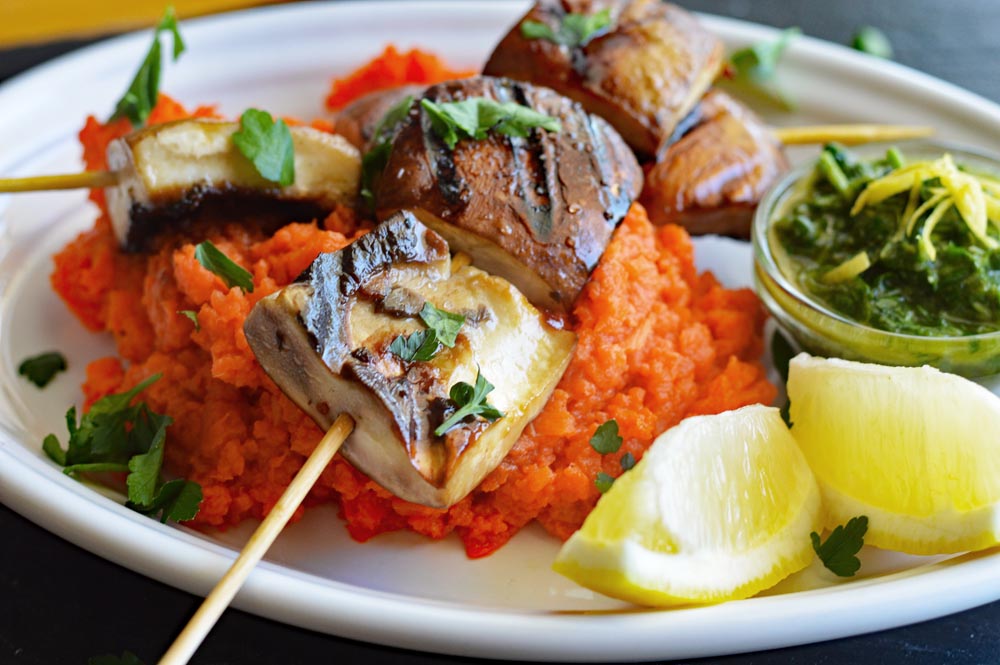 Close up of grilled portobellos with mashed carrots