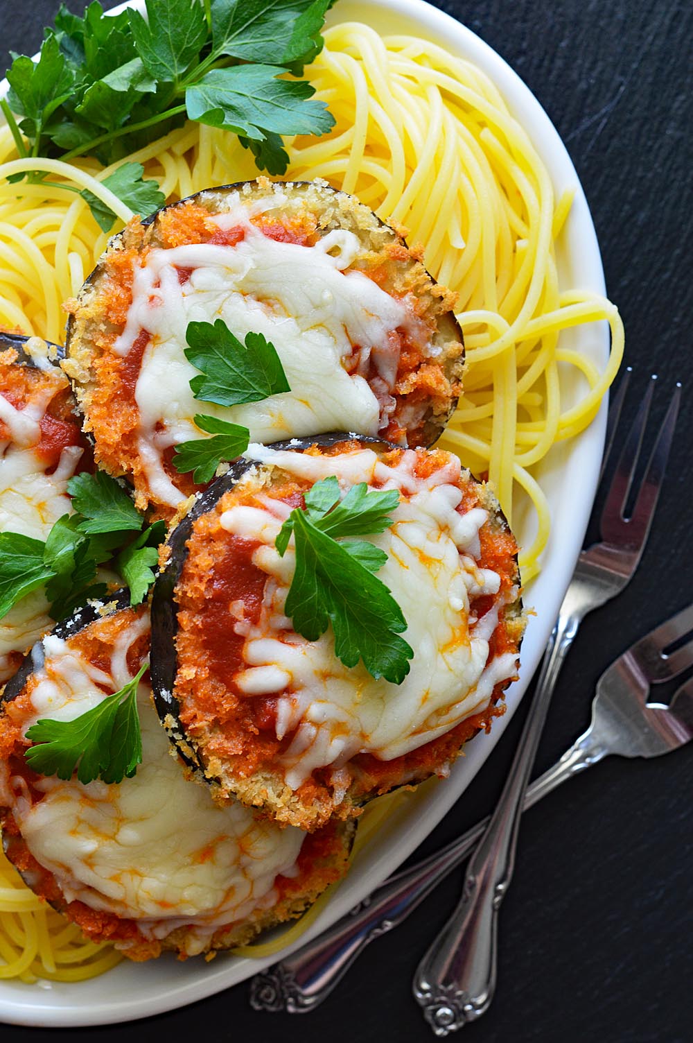 Overhead view of vegan air fryer eggplant parmesan with spaghetti