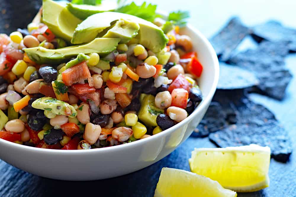 Photo of Cowboy Caviar a/k/a Texas Caviar with lemon wedges and avocado