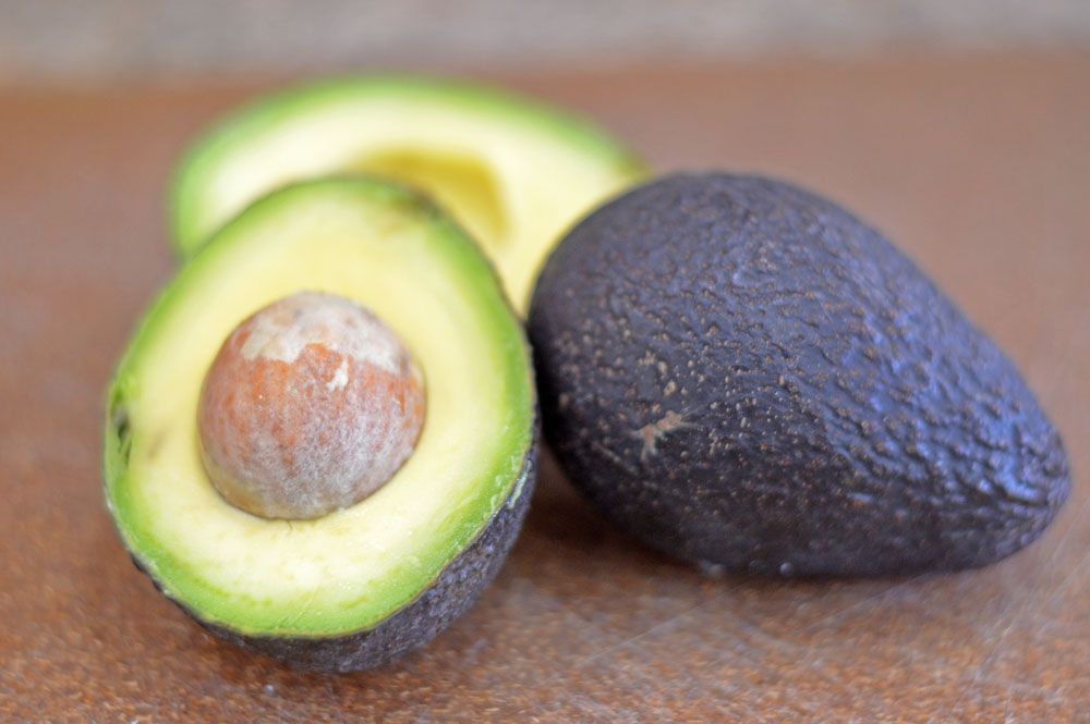 Halved avocado with pit