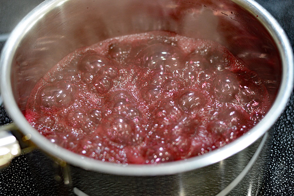 Boiling the blackberries to reduce the liquids