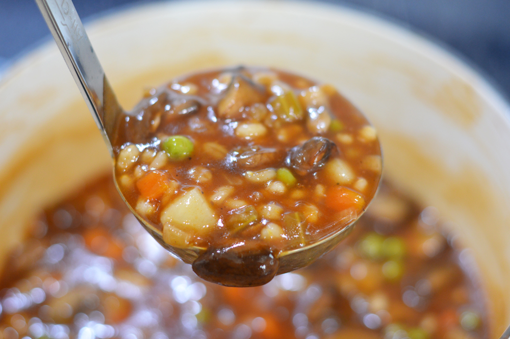 Ladle full of Vegan Mushroom Barley Soup