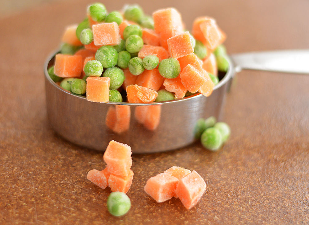 Peas and carrots in a measuring cup