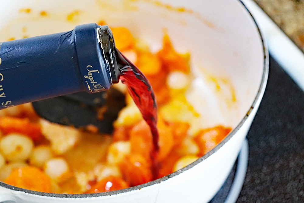 Adding wine to the vegetables