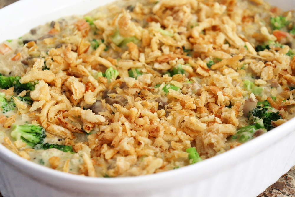 Adding fried onions to the top of the Creamy Vegan Broccoli Wild Rice Casserole