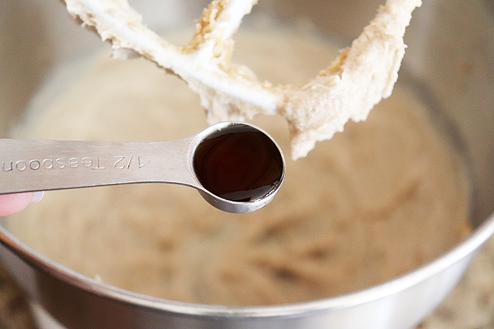 Adding vanilla to creamed butter and sugar mixture