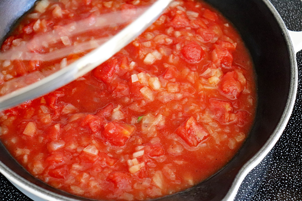 Covering the diced tomatoes to cook