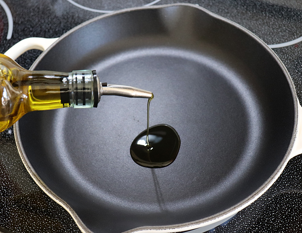 Adding olive oil to a skillet