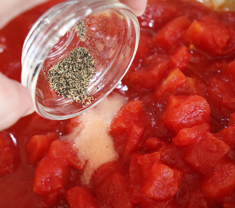 Adding pepper to diced tomatoes