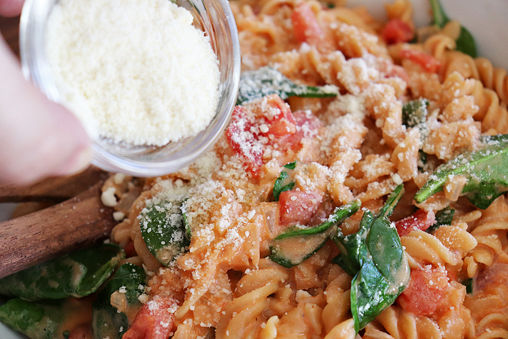 Adding grated parmesan to tomato cream sauce