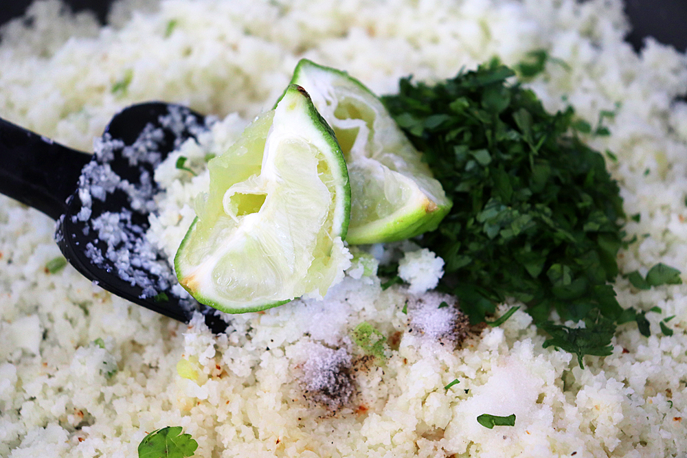 Limes in the pan with cauliflower rice and seasonings