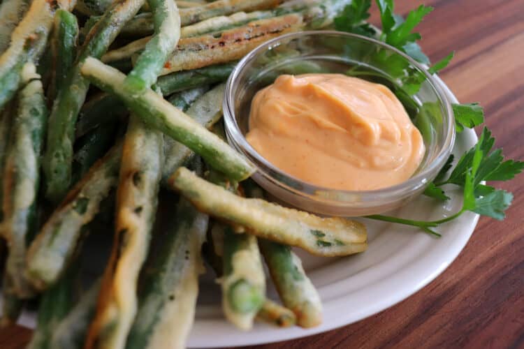 Super close shot of green beans and dip