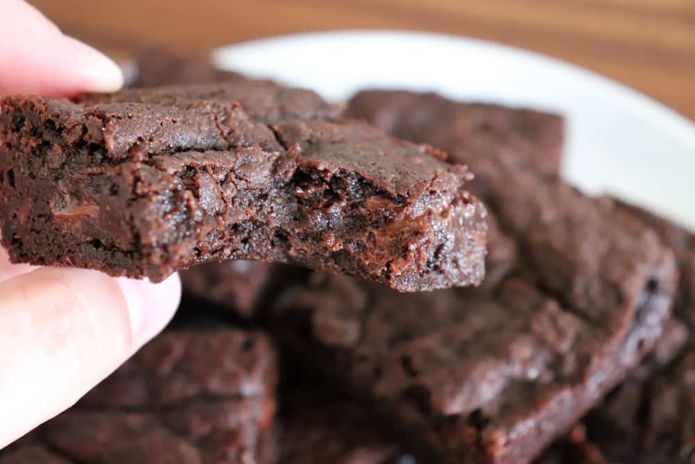 Close up shot of bite taken from brownie for Easy Vegan Brownies