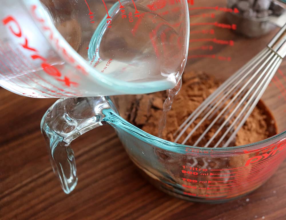 Adding boiling water to the chocolate for Easy Vegan Brownies