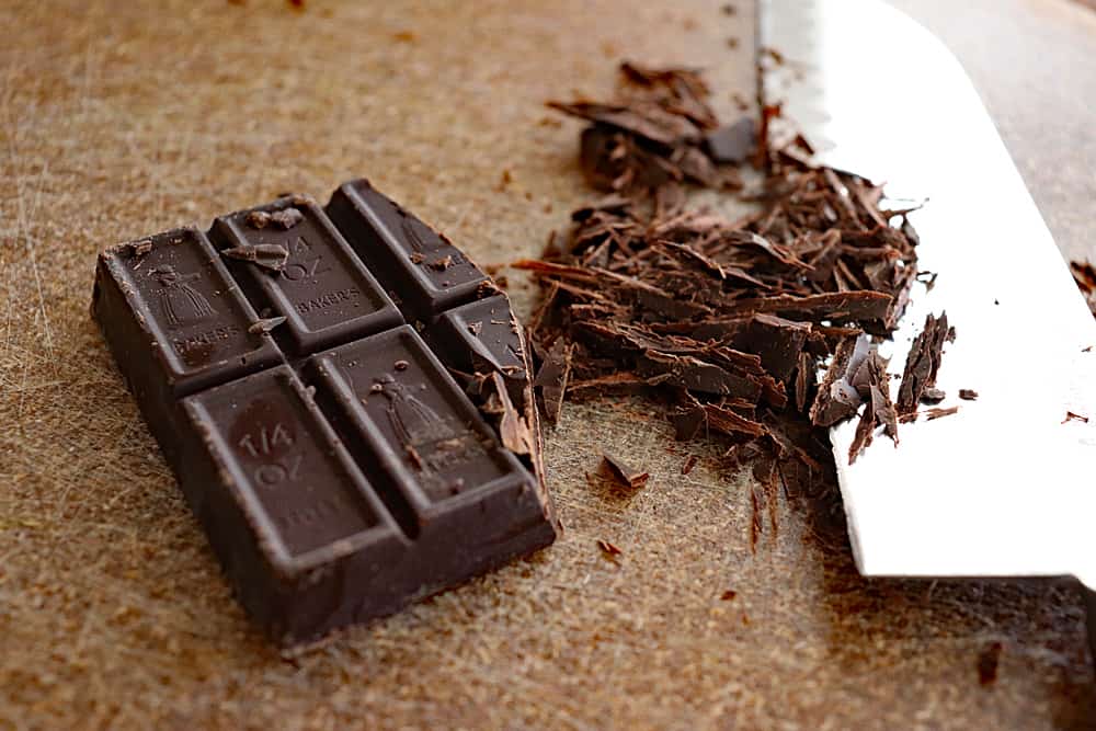 Chopped unsweetened chocolate with a knife for Easy Vegan Brownies