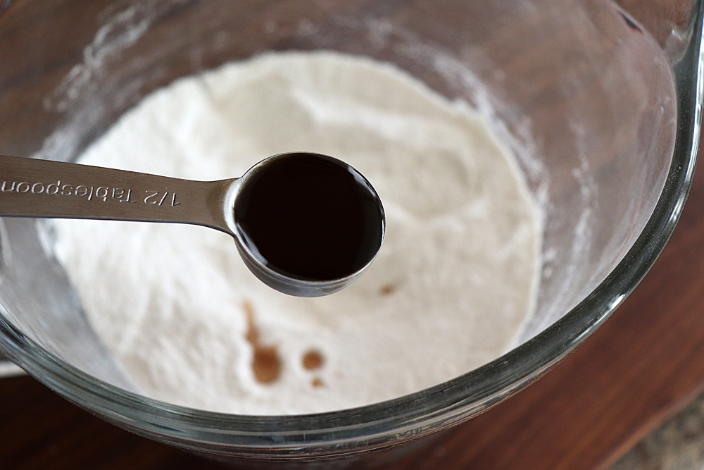 Vanilla extract in a measuring spoon for Easy Vegan Brownies