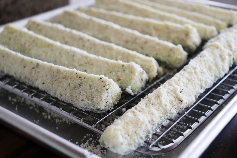 breaded zucchini strips on a rack