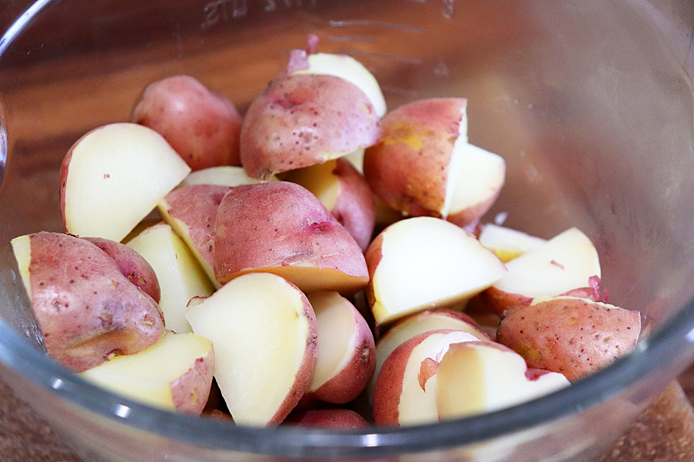 Cut potatoes in a glass bowl for Vegan German Potato Salad Recipe