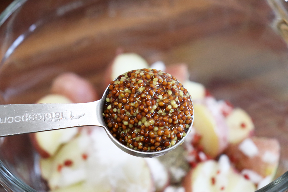 Adding whole grain mustard to the potatoes