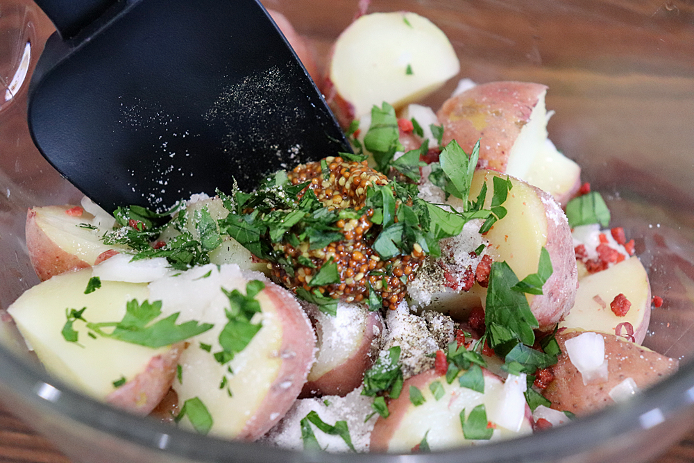 Adding parsley to the warm potatoes