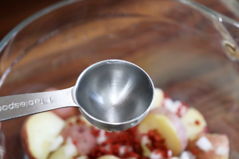 Adding white vinegar to the potatoes