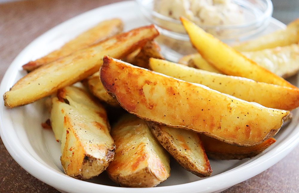 Hero Shot of Oven Roasted Potato Wedges with Vegan Mustard Butter