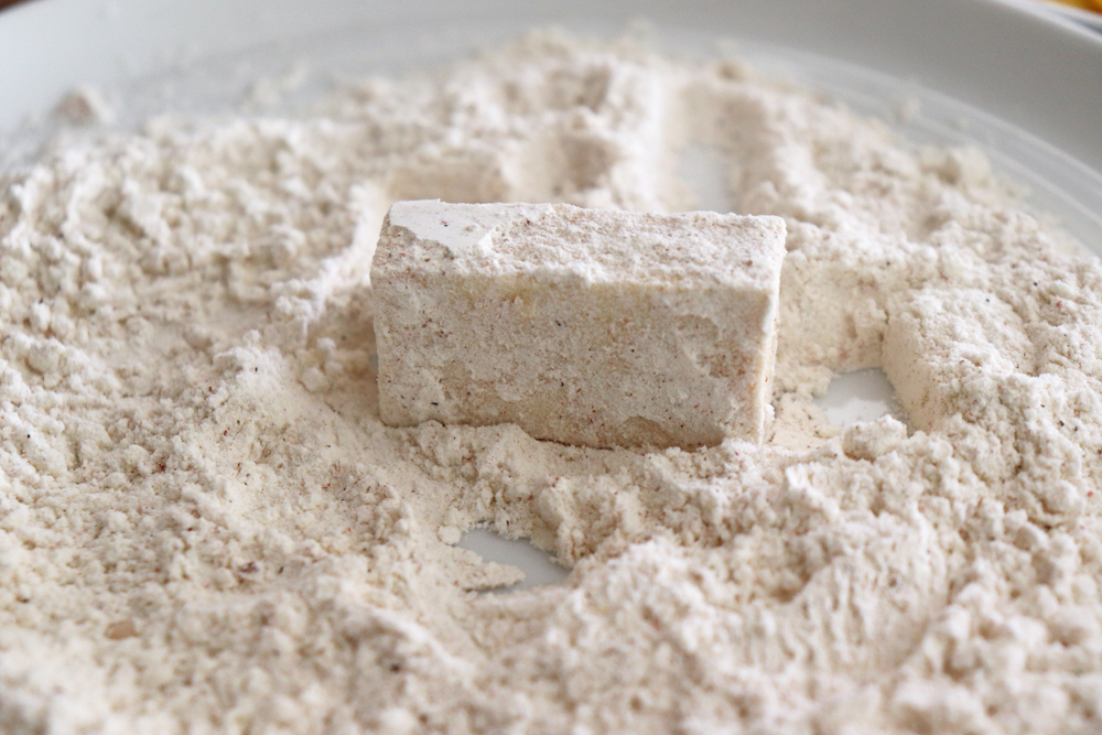 Rolling the tofu in flour