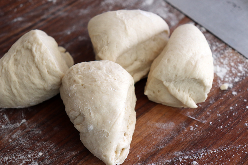 Cutting dough into four pieces