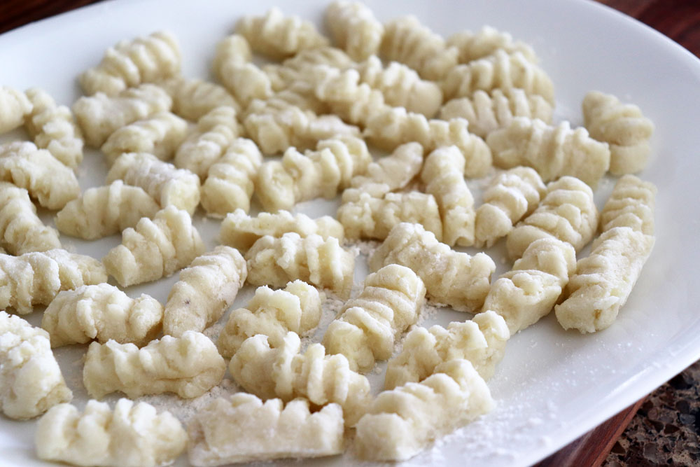 Plate of formed gnocchi ready to cook for Easy Homemade Vegan Gnocchi Recipe