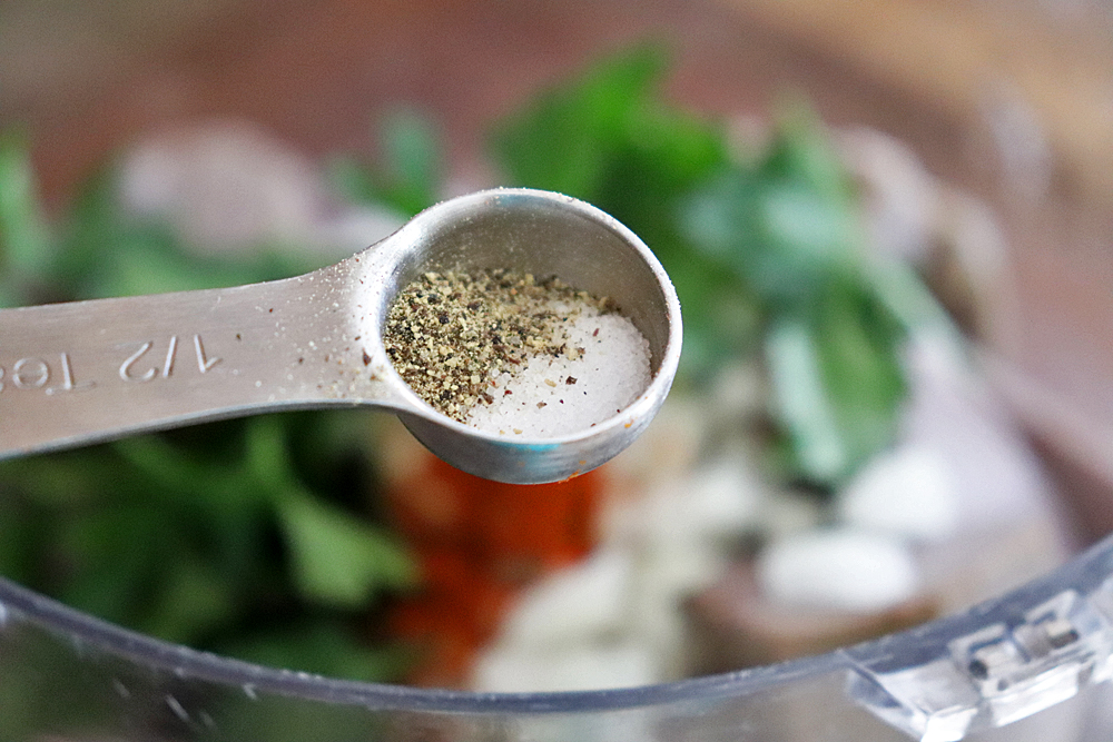 Adding salt and pepper to the food processor