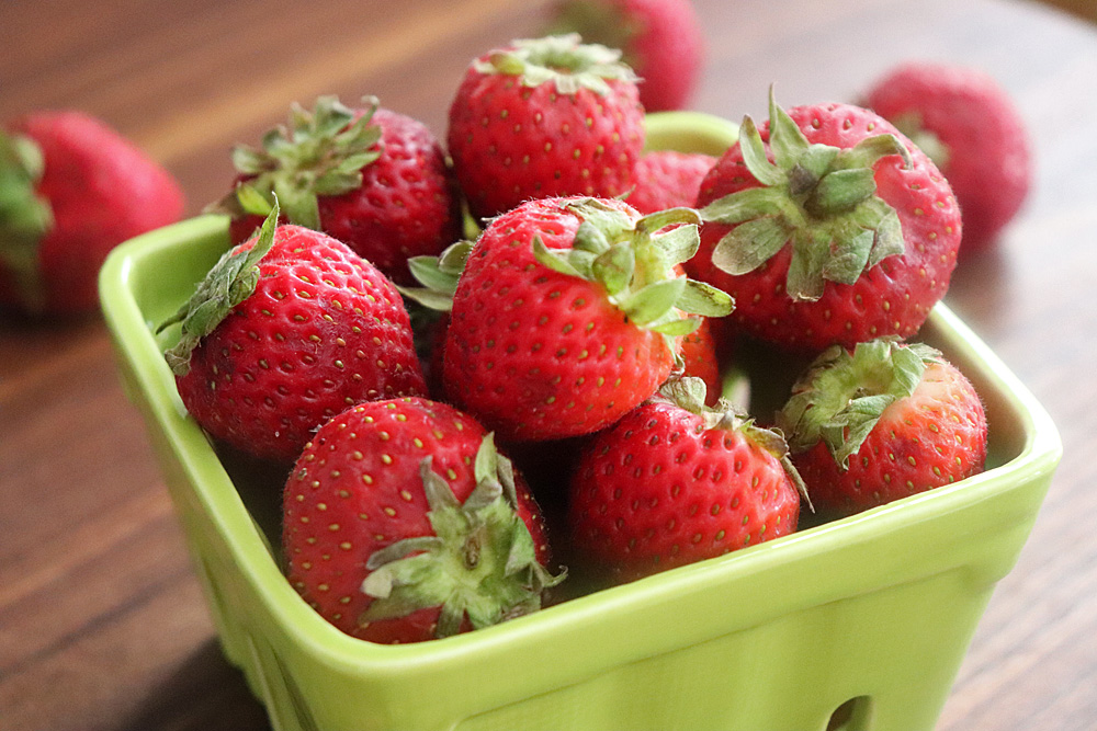Fresh Strawberries in a green basket for Easy Macerated Strawberries with Sugar 