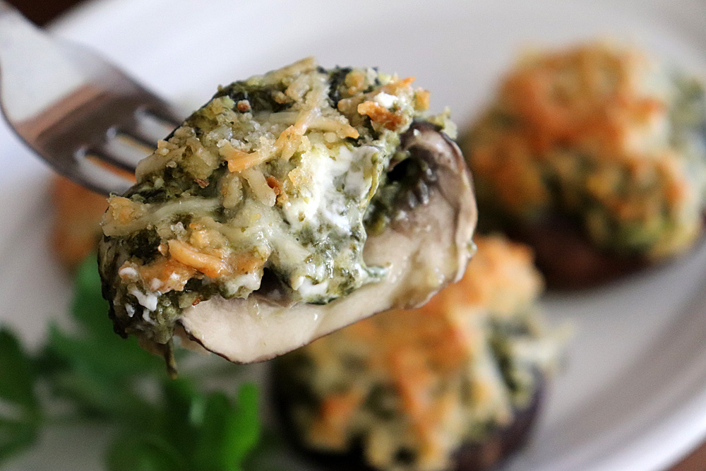 Bite shot of Easy Spinach Stuffed Mushrooms Recipe